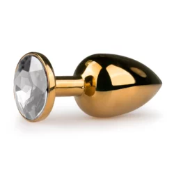 Goudkleurige metalen buttplug met transparante steen en platte onderkant